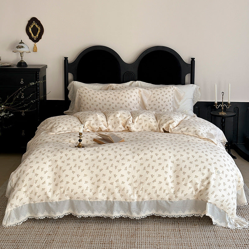 Cotton muslin bedding set with ruffles, lace trim, and delicate bow print