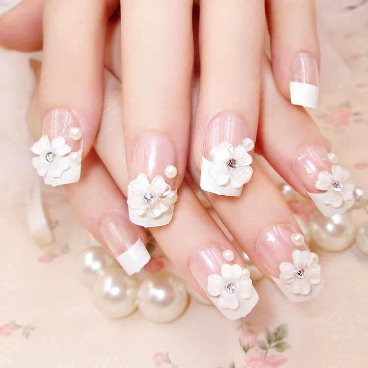 Artificials nails with sparkling rhinestone accents and elegant flower embellishments Stornfield