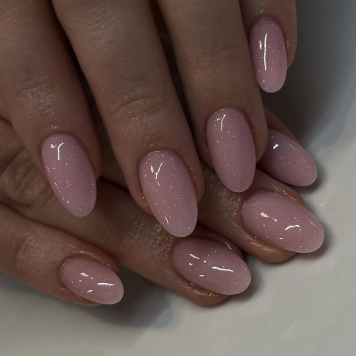 Artificial nail extensions with glitter accents Stornfield
