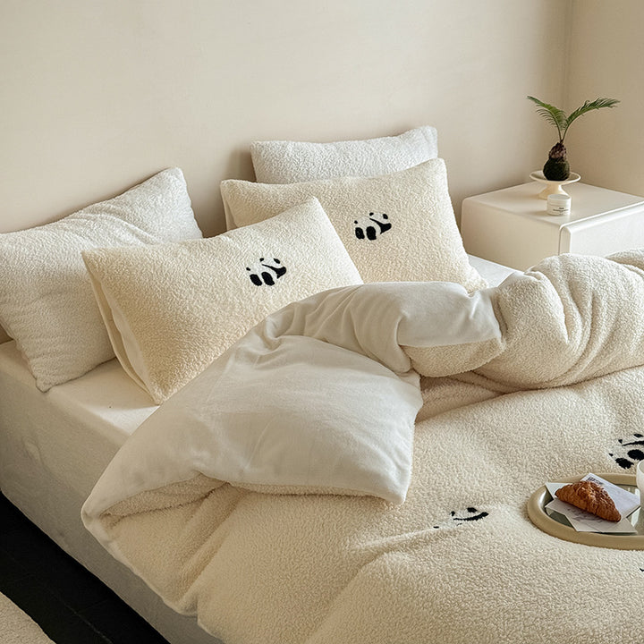 Cozy sherpa bedding set with embroidered penguin motifs and reversible function