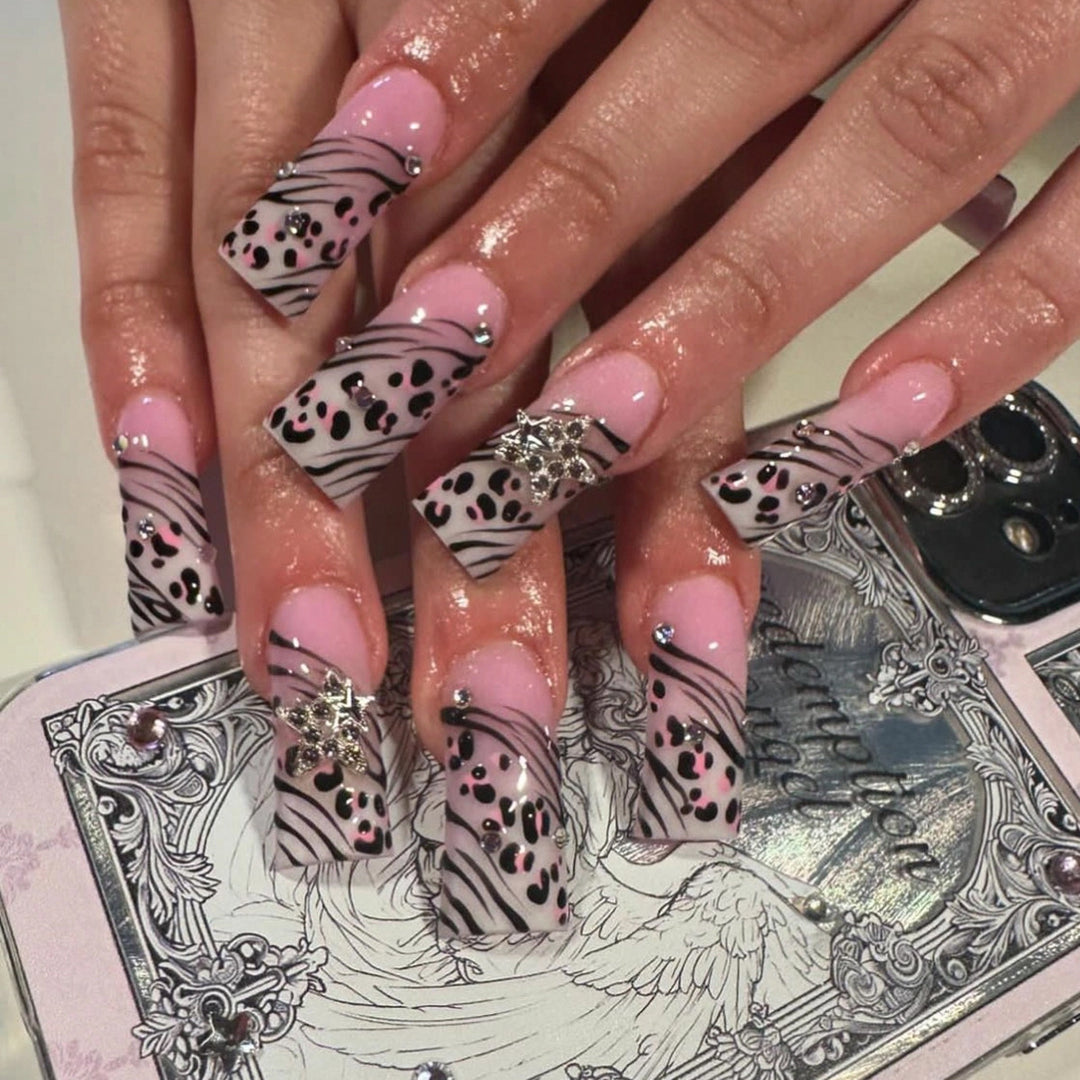 Artful Nail Art with Zebra Pattern and Glitter Accents Stornfield