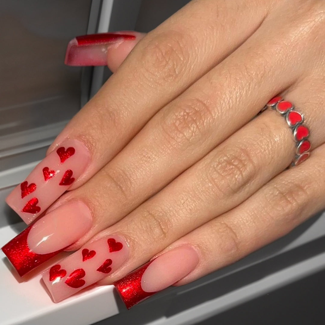 Acrylic nail set with glamorous heart designs and glitter accents Stornfield