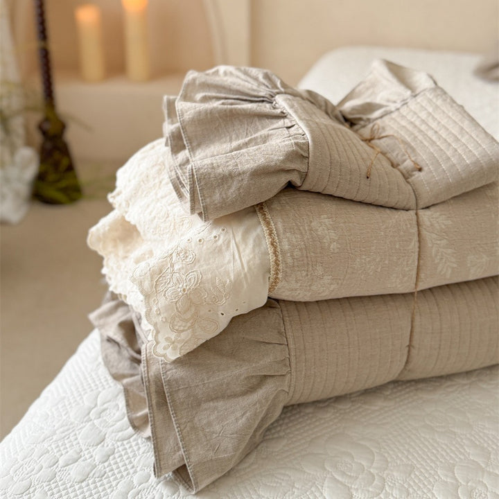 Luxurious quilted cotton bedding set with ruffles and embroidered details