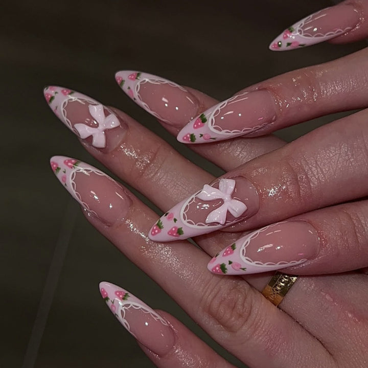 Artful stiletto nails with floral accents and bow embellishments Stornfield
