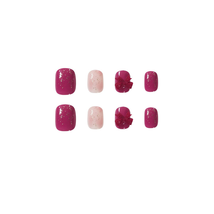 Artificial nail art with glitter embellishments and cute bow motif Stornfield