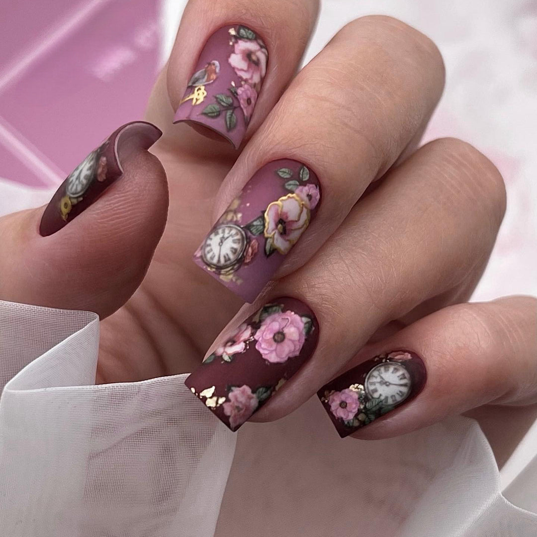 Nail art with floral design and intricate clock motifs Stornfield