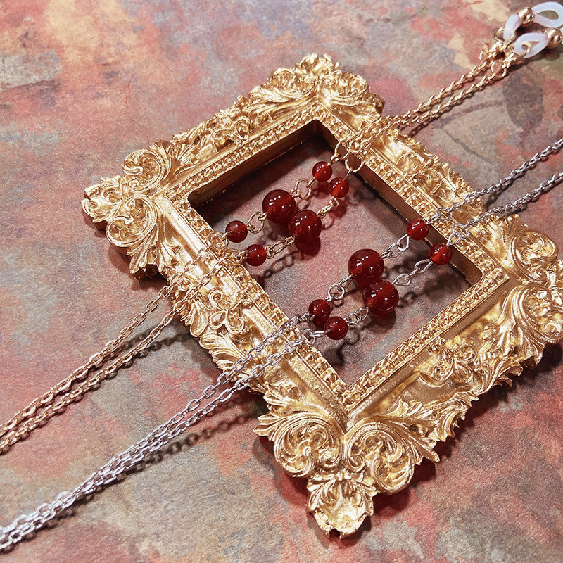 Elegant jewelry holder chain with red accents Stornfield