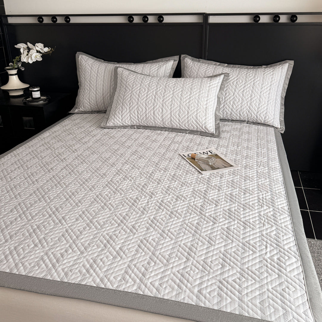 Quilted bedspread and pillow set with geometric striped quilting