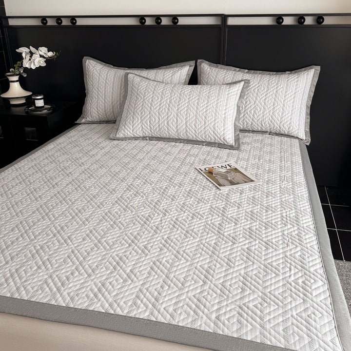 Quilted bedspread and pillow set with geometric striped quilting
