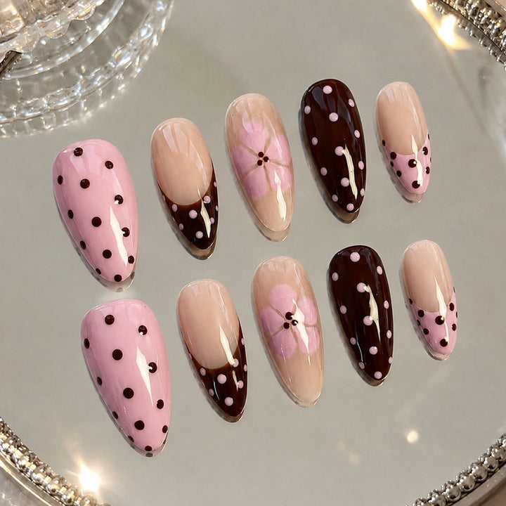 Artificial nail set with playful dots and floral accents Stornfield
