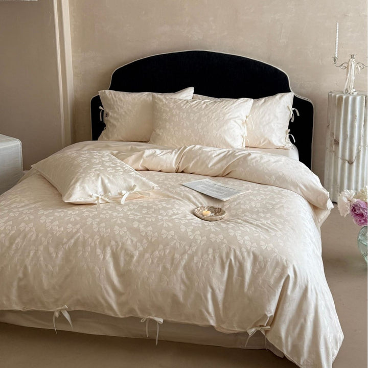 Luxurious cotton satin bed set with delicate ribbon ties and jacquard relief