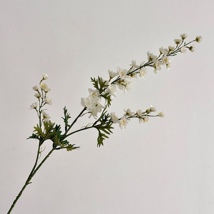 Artificial flower branch with intricately detailed red flowers