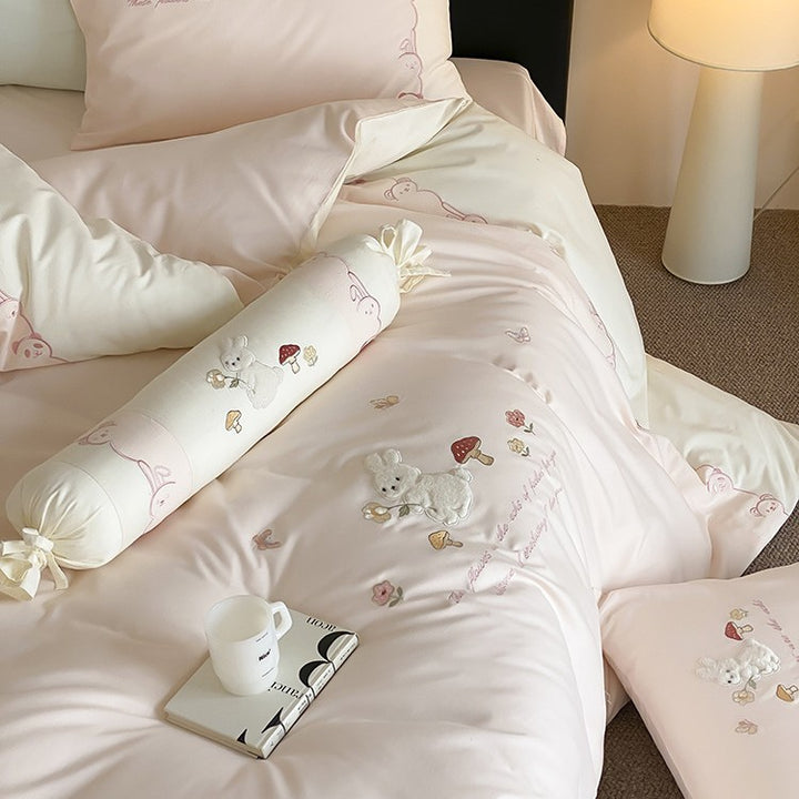 Playful cotton bedding set with plush bunny appliqué and round cushion