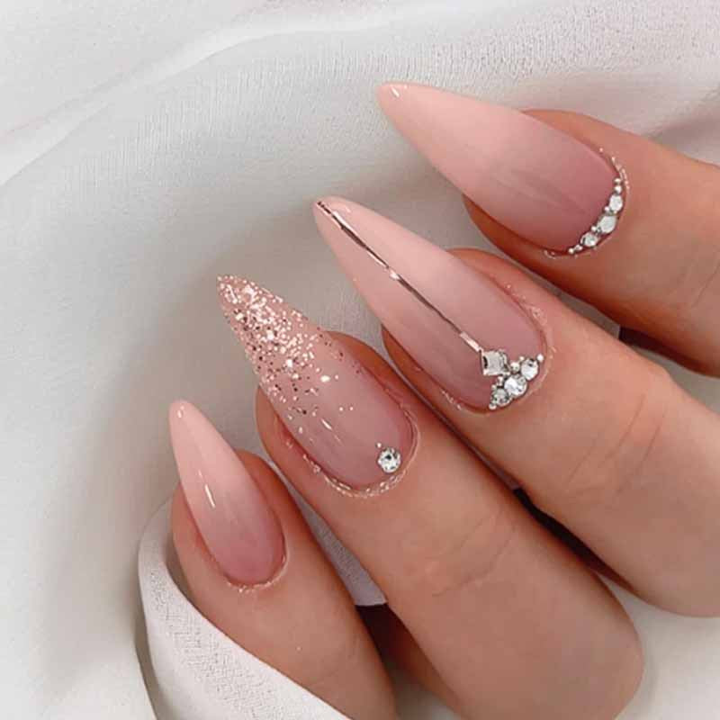 Glamorous artificial nails with rhinestone accents and shimmering effects Stornfield