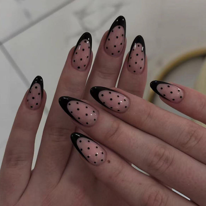 Artistic stiletto nails with black dot pattern Stornfield