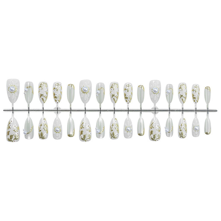 Acrylic nail set with elegant floral designs and glamorous glitter accents Stornfield