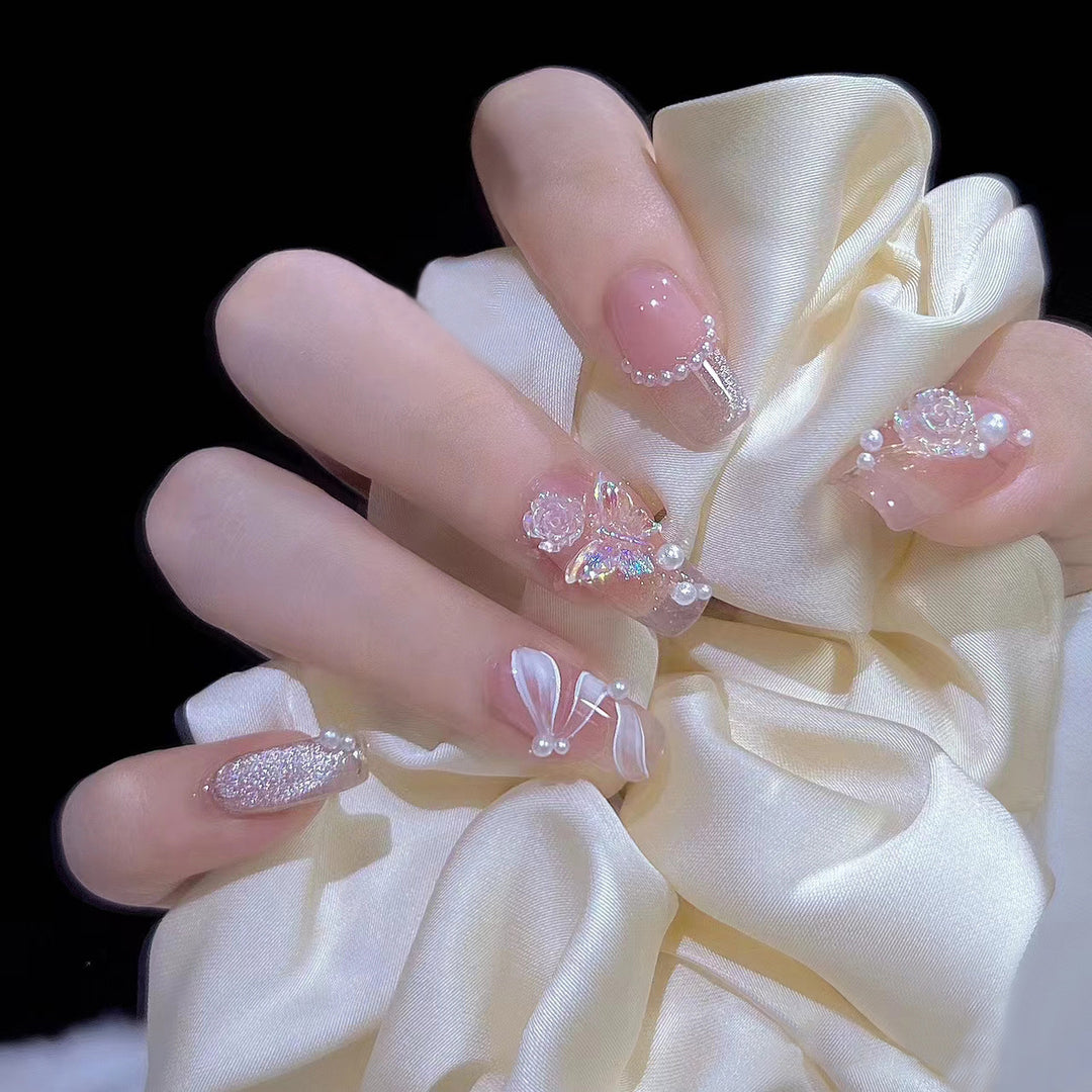 Artificial nails with glitter accents and playful motifs Stornfield