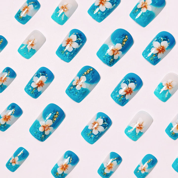 Artificial nails with floral accents and glitter patterns Stornfield