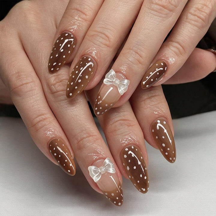 Artistic stiletto nails with delicate bow motif Stornfield