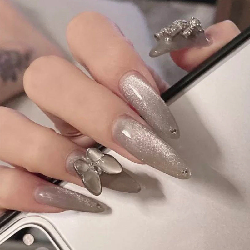Glamorous stiletto nails with radiant glitter and elegant 3D design Stornfield