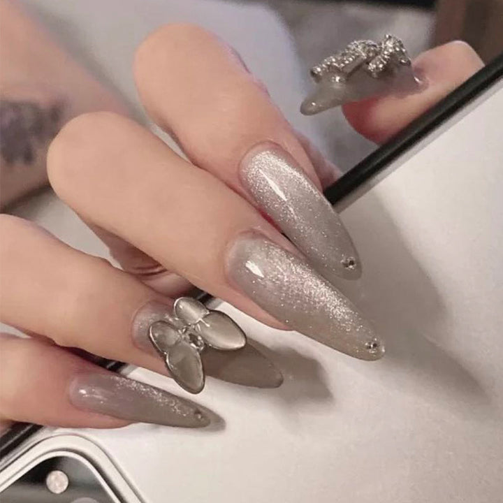 Glamorous stiletto nails with radiant glitter and elegant 3D design Stornfield