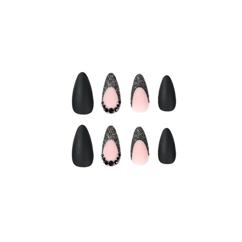 Artful stiletto nails with elegant black design and glitter accents Stornfield