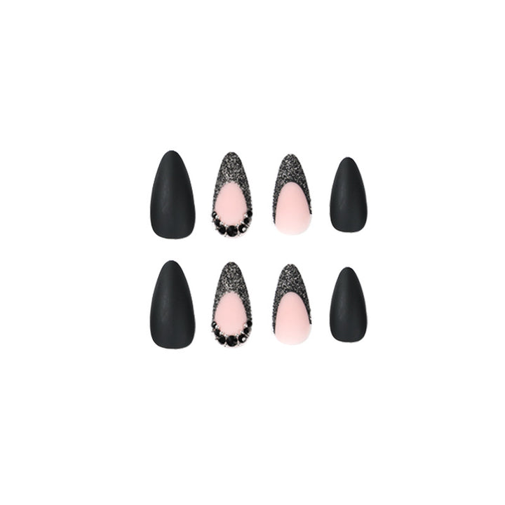 Artful stiletto nails with elegant black design and glitter accents Stornfield