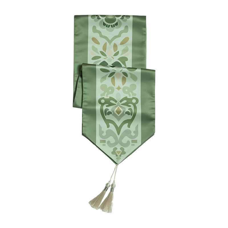 Handcrafted satin table runner with Oriental medallion pattern and decorative tassels