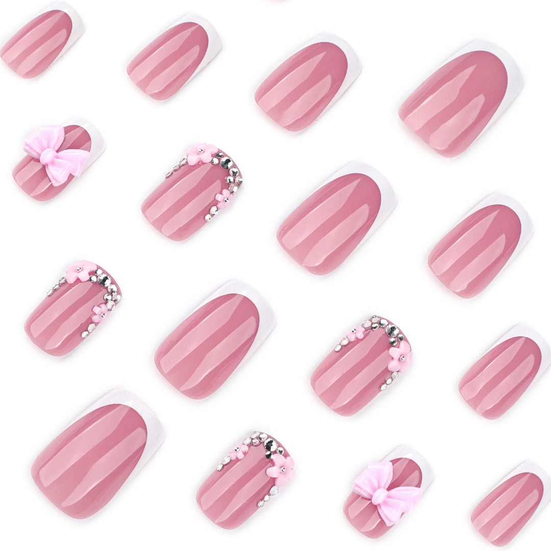 Artful nail extensions with sparkling accents and bow decorations Stornfield