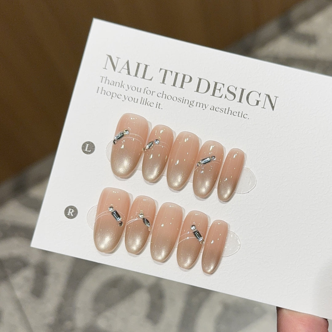 Artificial nail tips with elegant gradient color and rhinestone accents Stornfield