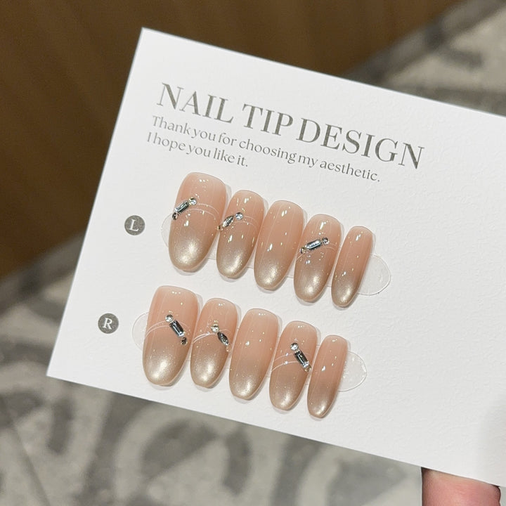 Artificial nail tips with elegant gradient color and rhinestone accents Stornfield