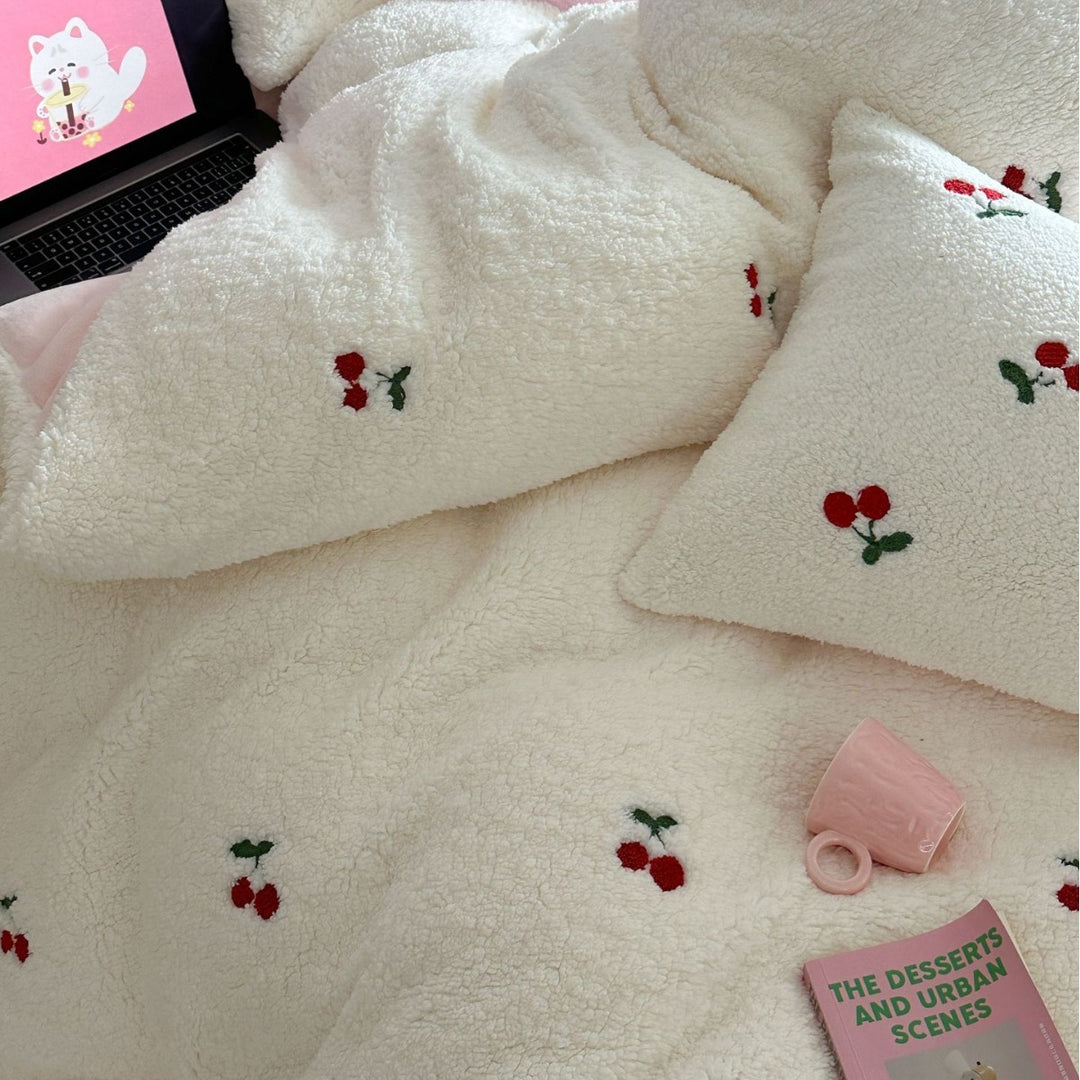 Cozy Sherpa blanket with embroidered teddy and cake motifs