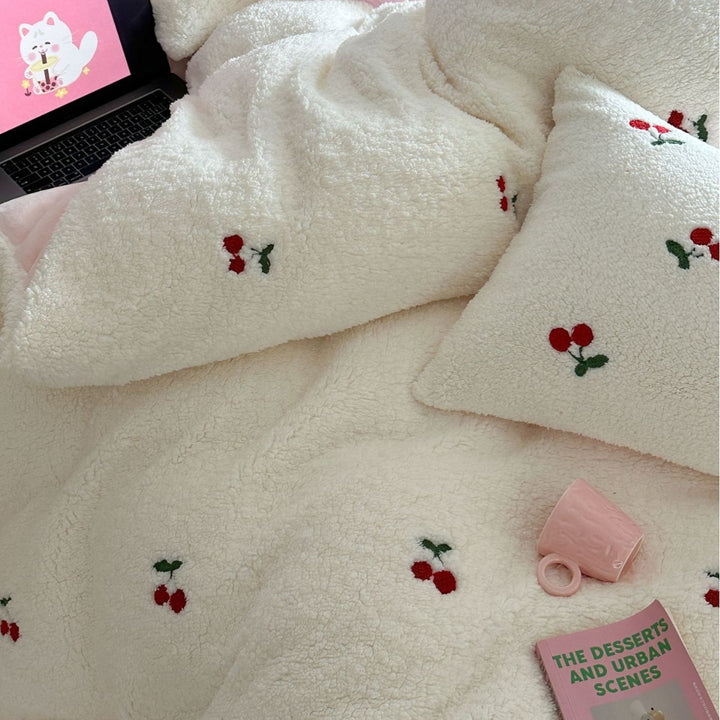 Cozy Sherpa blanket with embroidered teddy and cake motifs