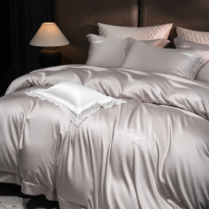 Luxurious satin bedding set with embroidered swan motif and lace pillow