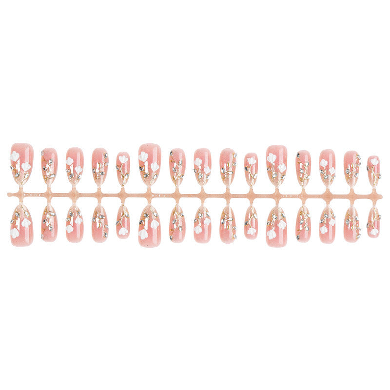 Artificial nail set with delicate floral patterns and elegant accents Stornfield