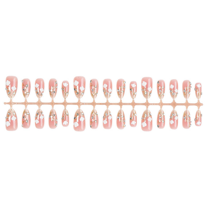 Artificial nail set with delicate floral patterns and elegant accents Stornfield