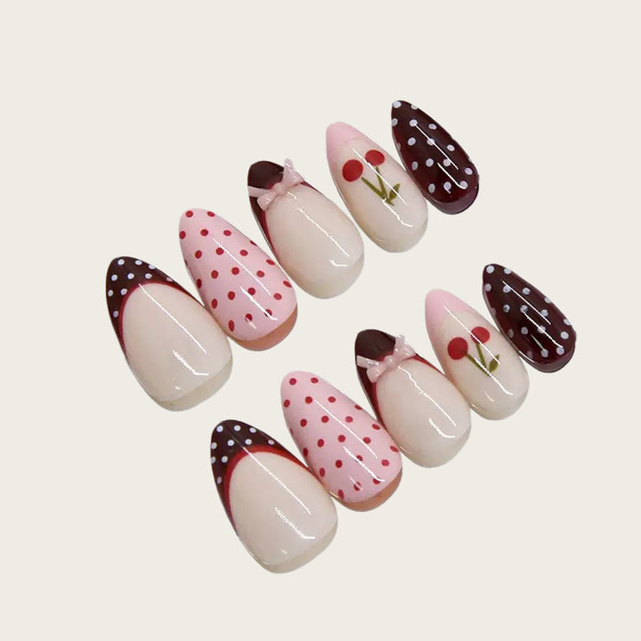 Artfully designed nail tips with cherry and dot motifs Stornfield