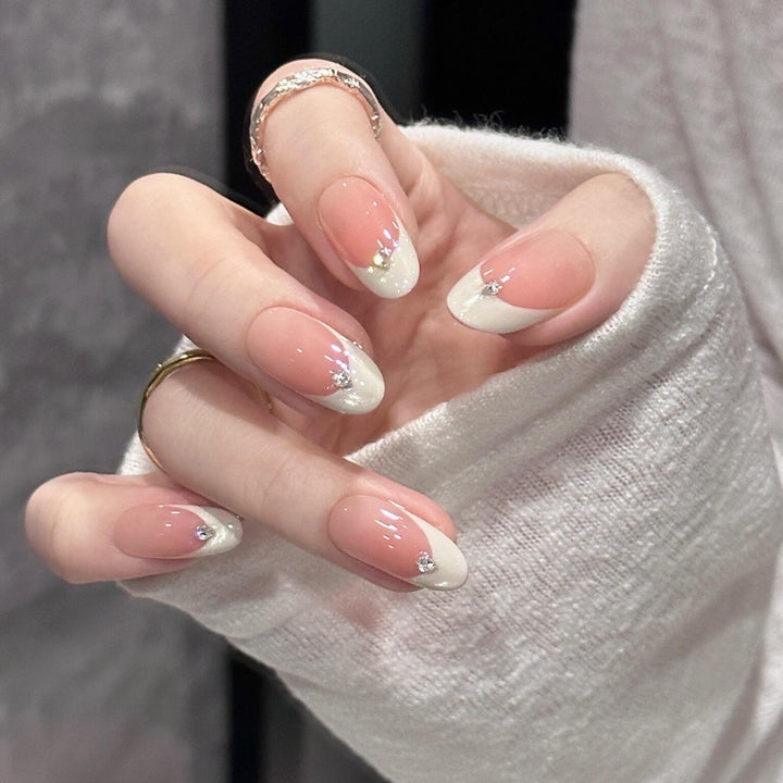 Artificial nails with elegant French style and sparkling accents Stornfield