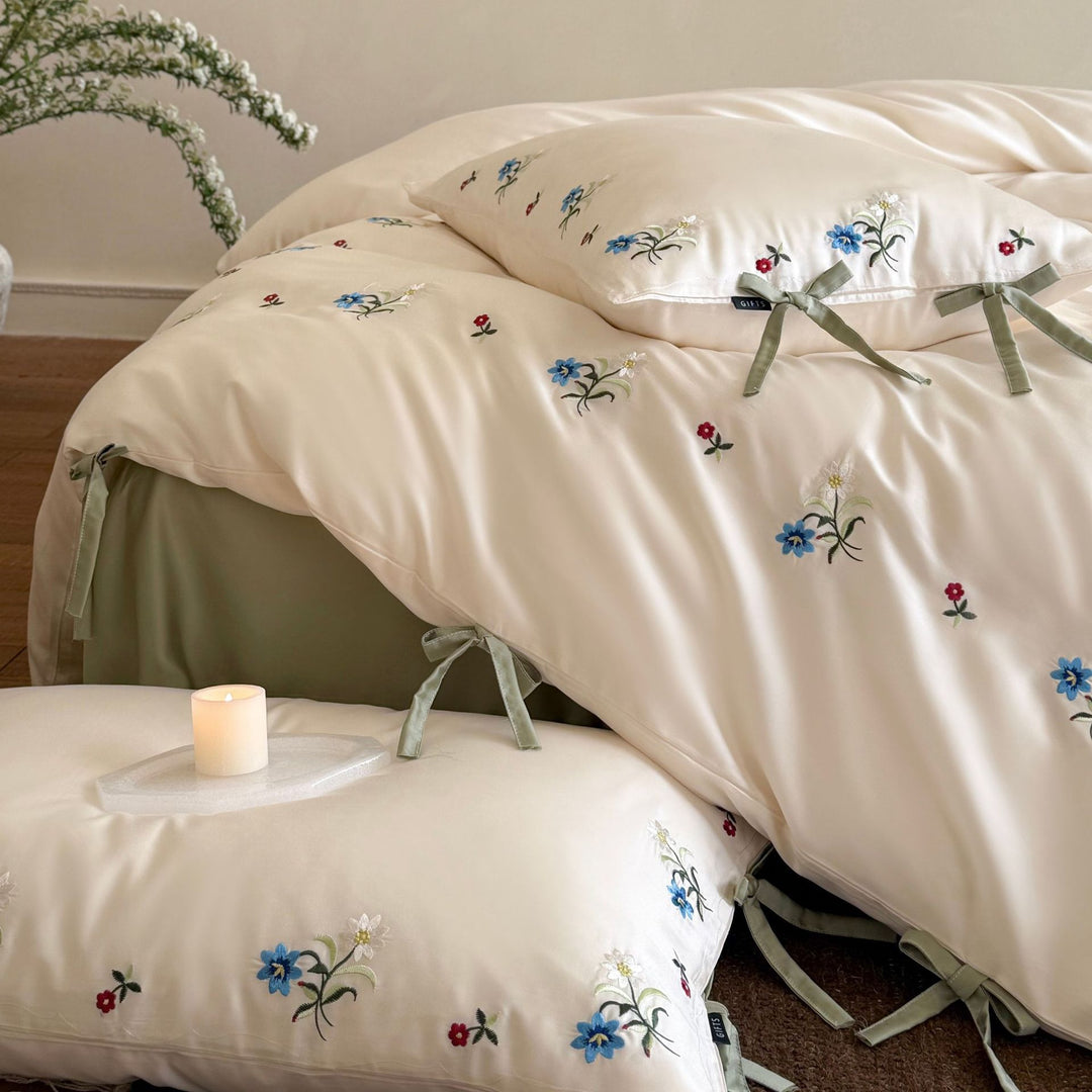 Luxurious satin bedding with floral embroidery and bow closure