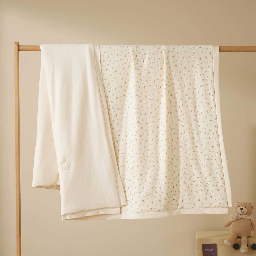 Double-layer baby crawling blanket made of cotton jersey with light padding and delicate all-over animal print
