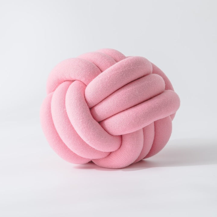 Decorative knitted knot cushion as a decorative pillow made of soft jersey