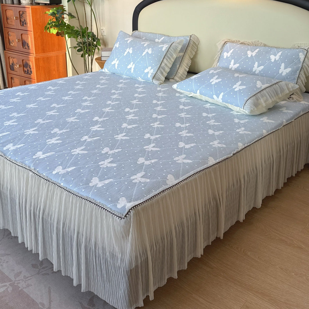 Quilted mattress and pillow set with butterfly motif and pleated bed ruffle