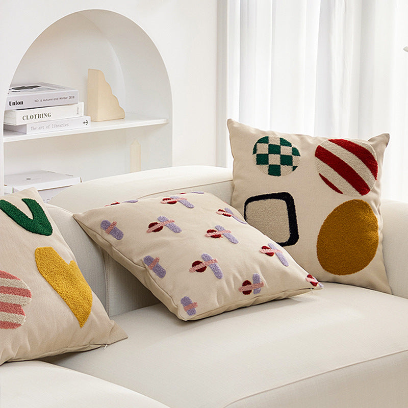 Square cushion cover with hand-tufted geometric applications