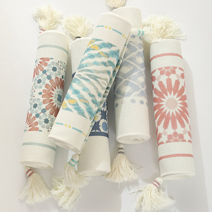 Web table runner made of cotton blend with woven diamond design and tassels