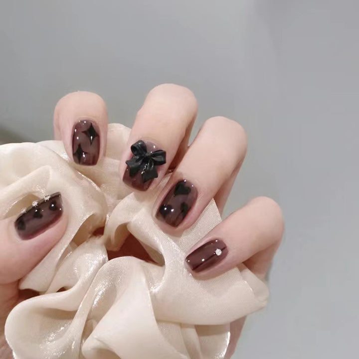 Artificial nails with elegant ribbon and heart designs Stornfield
