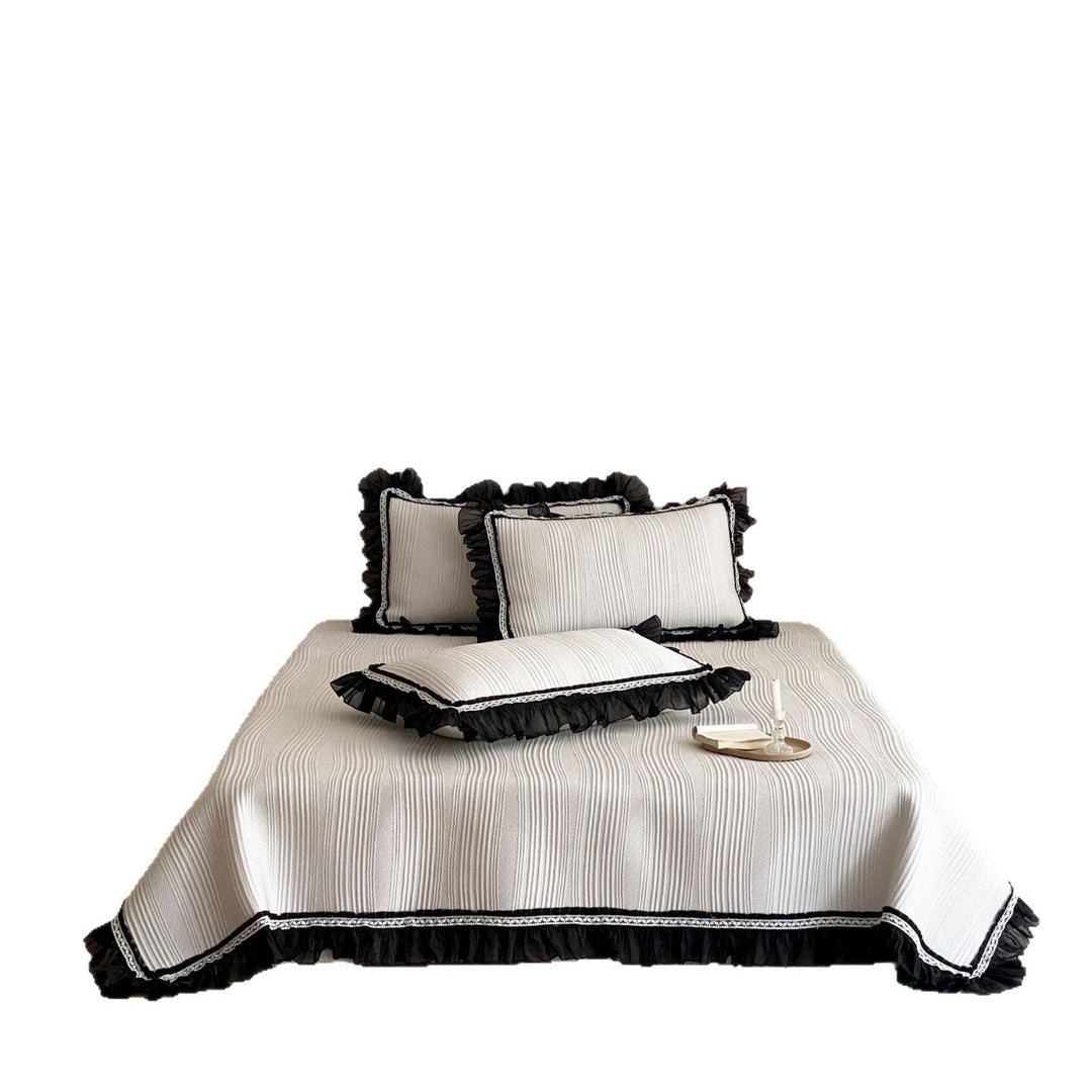 Bedspread with structured wave pattern surface and decorative ruffle trim