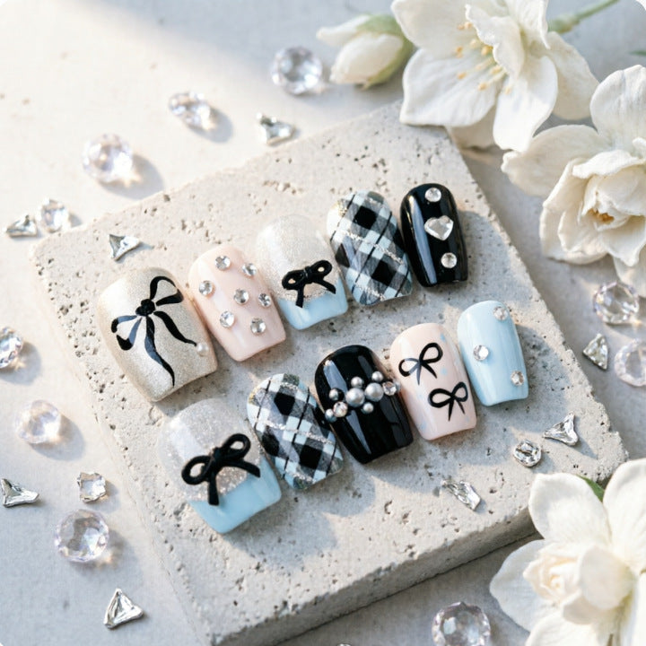 Artificial nails with elegant bows and rhinestones Stornfield