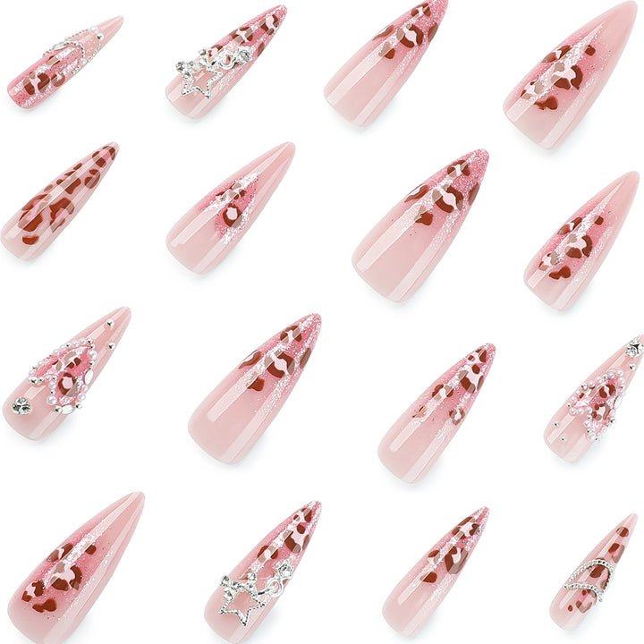 Artistic stiletto nails with glitter and jewelry accents Stornfield