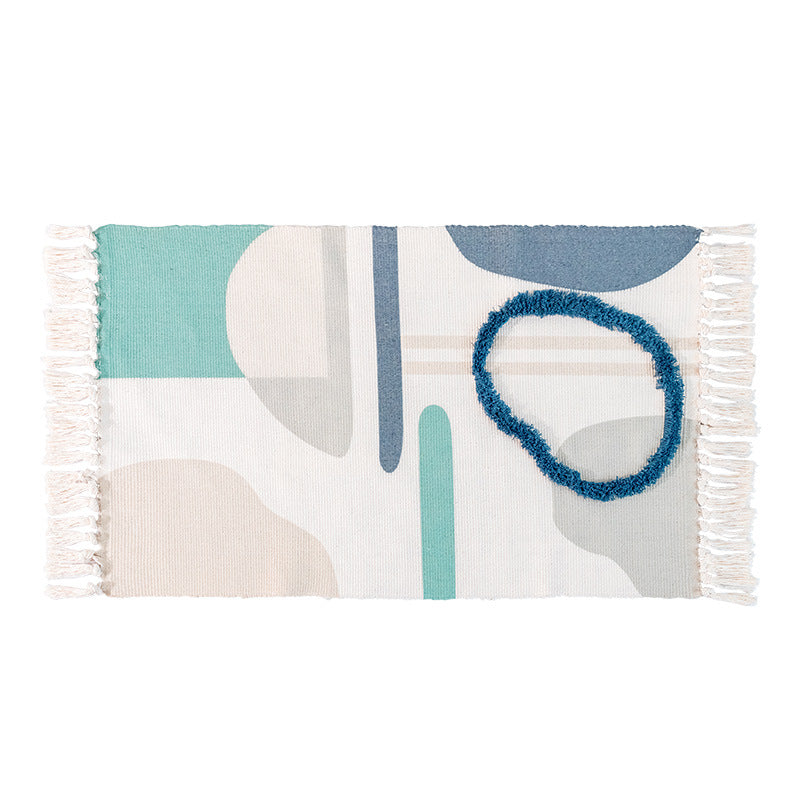 Hand-tufted cotton bath mat with botanical pattern and decorative fringes