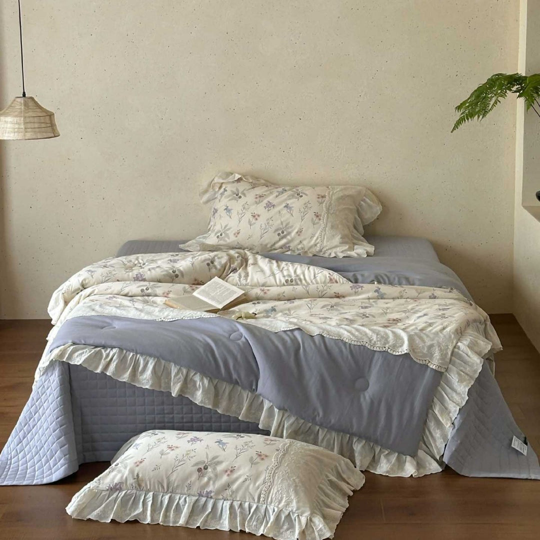 Romantic quilted bedspread and bedding set with ruffle and floral linen look